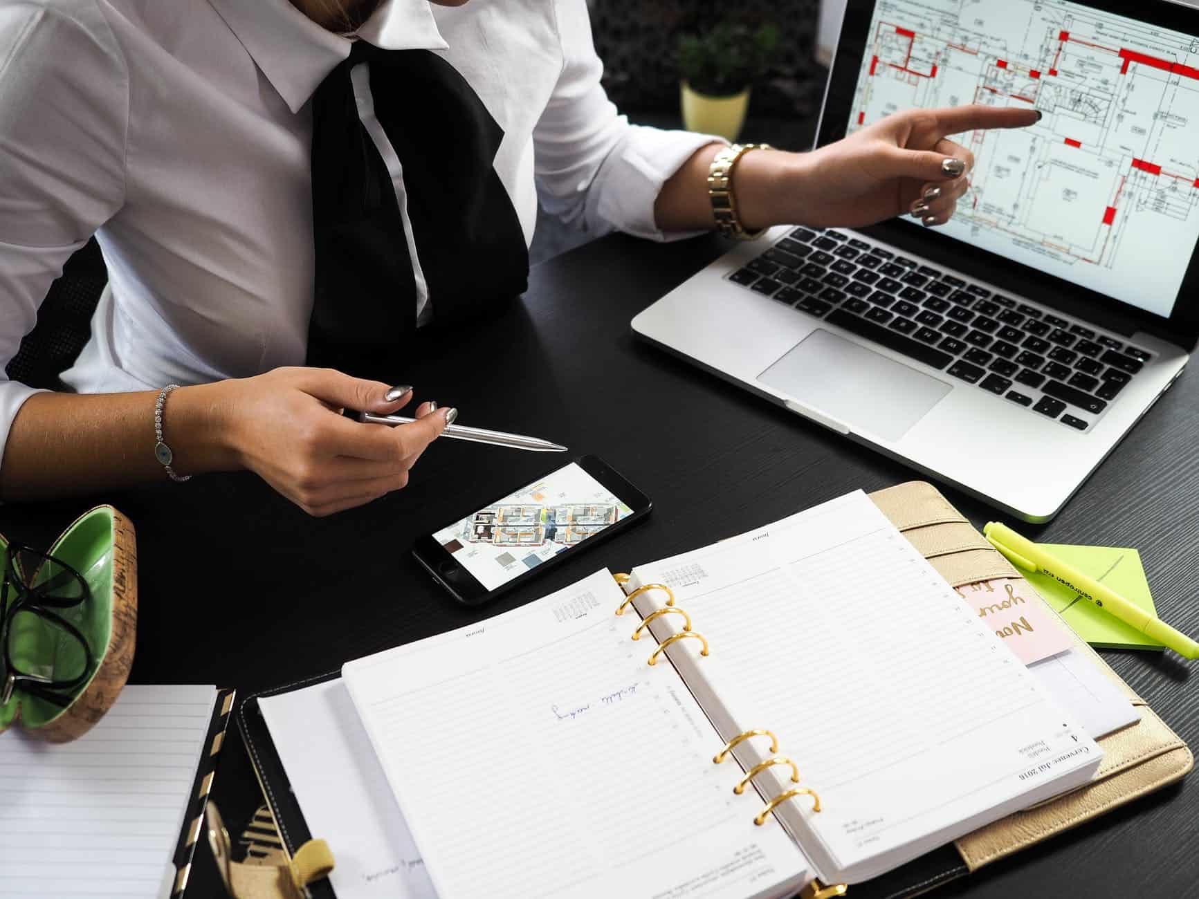 A small business leader explaining something on her laptop using an illustration.